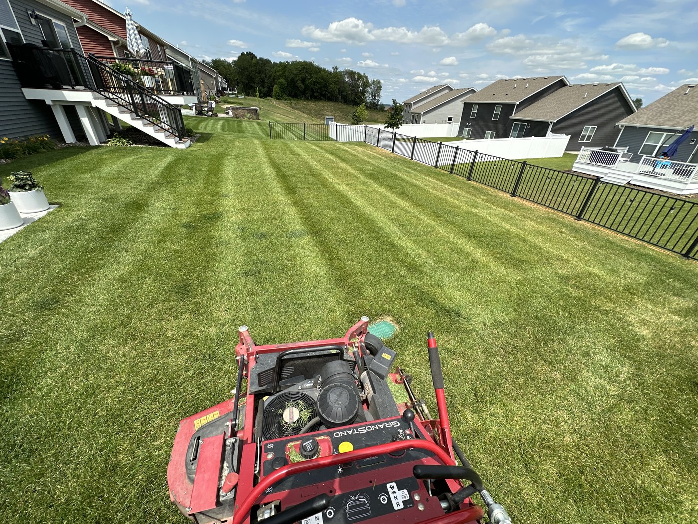 Striping a backyard from the stand-on mower — our own crew’s view of the work