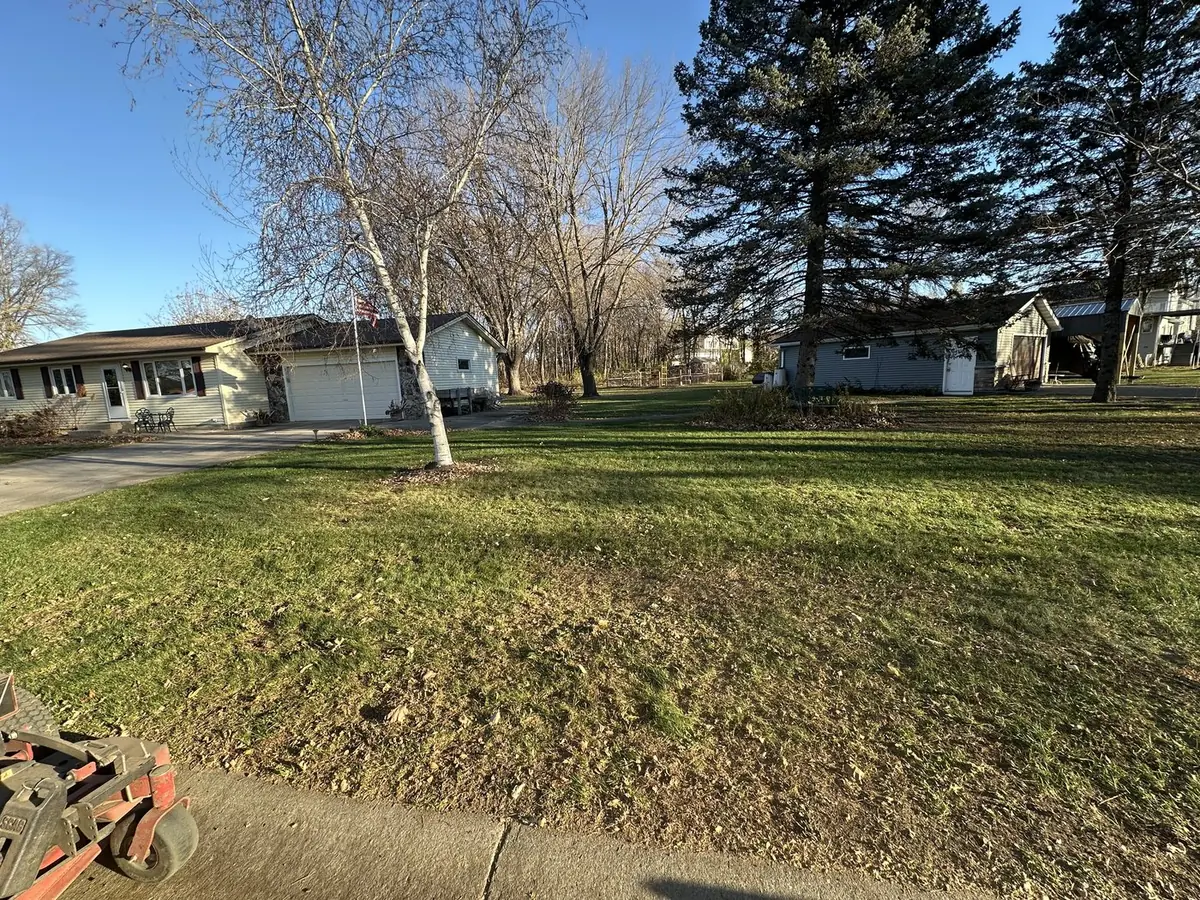 A late-fall lawn with the mower deck at the curb