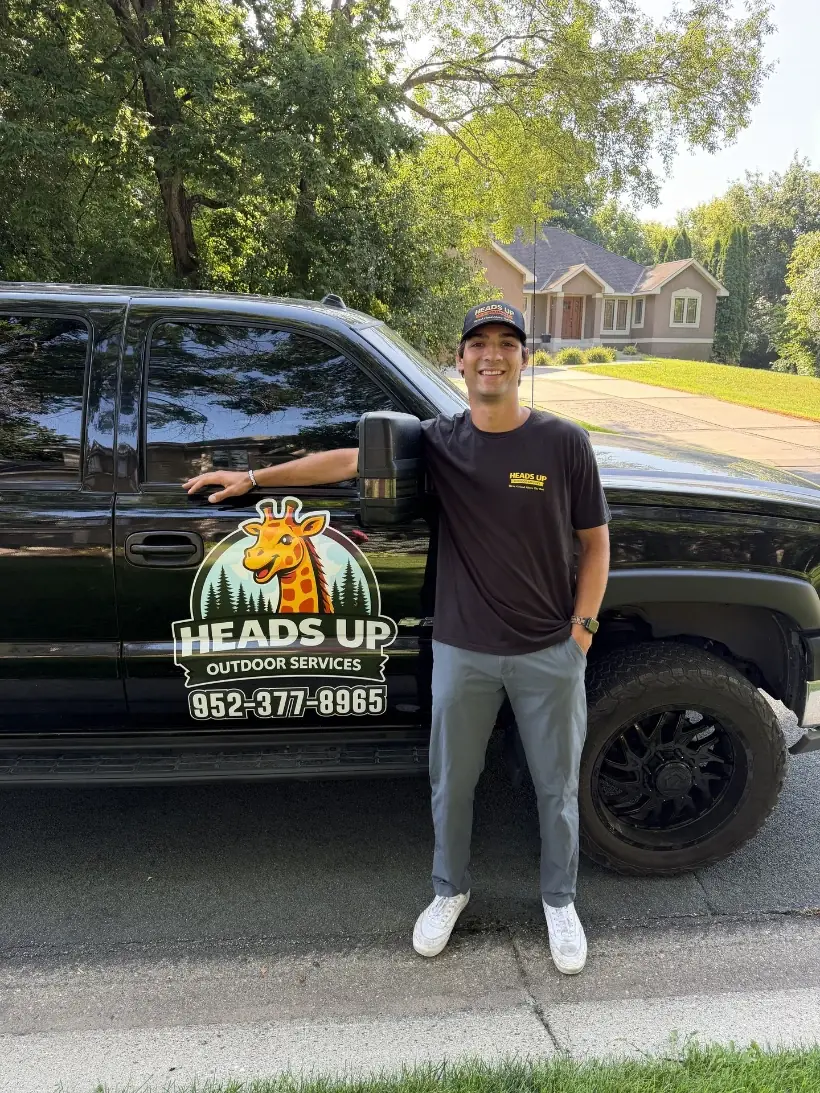Kevin Krenik, owner of Heads Up Outdoor Services, at the work truck in Shakopee