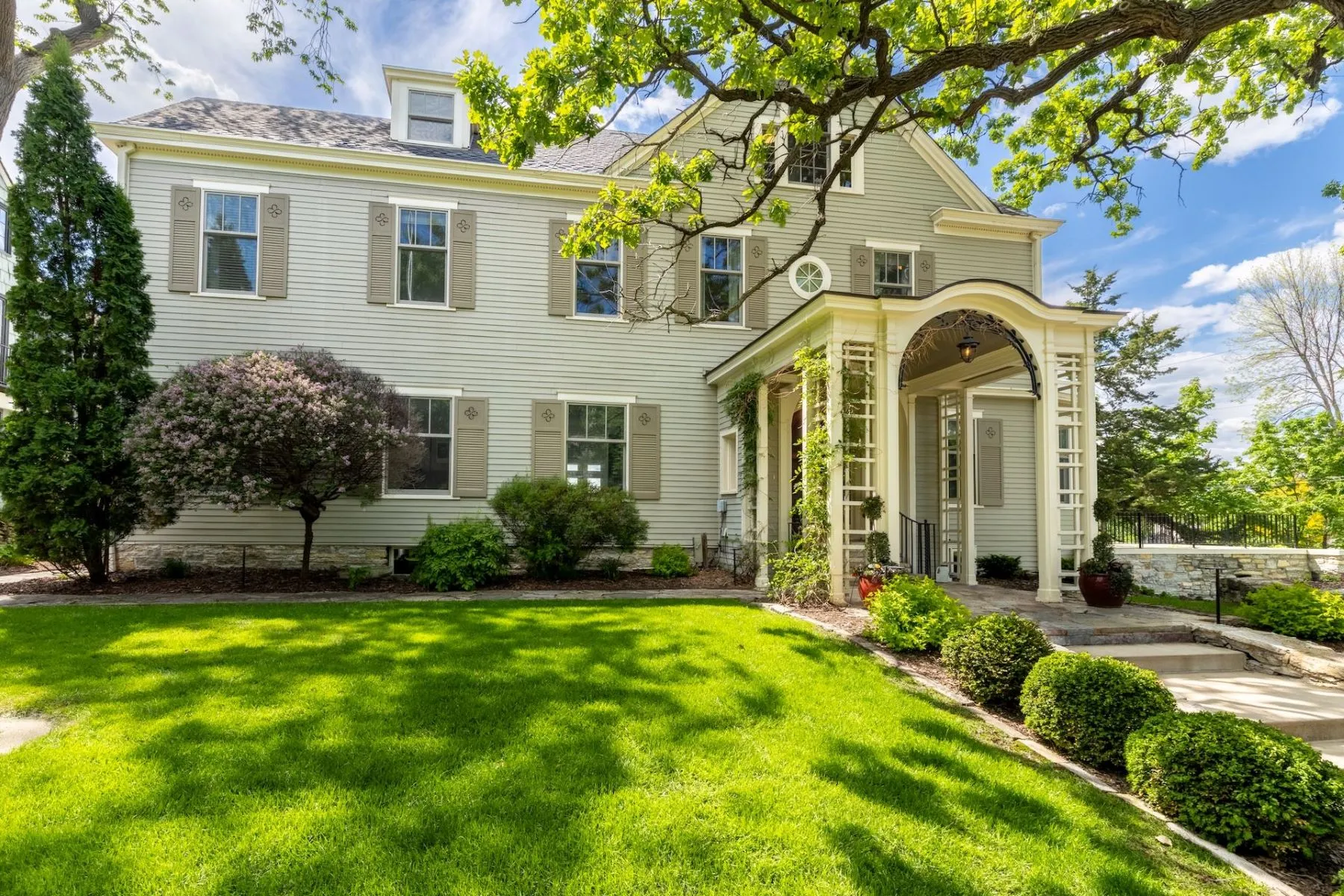 A designed front landscape at a stately Twin Cities home