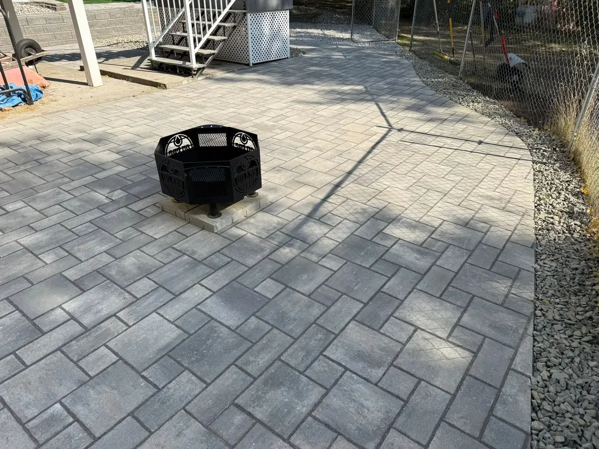 A finished paver patio with a fire ring — our own build