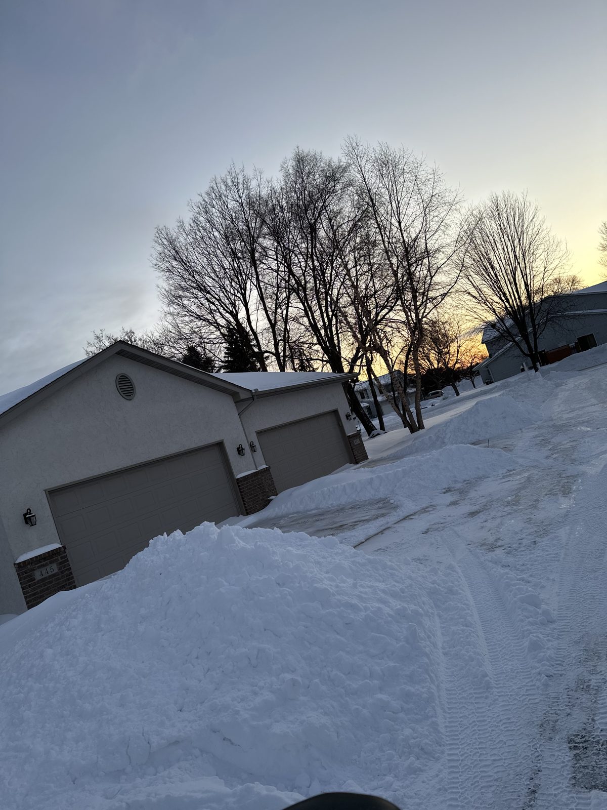 Freshly plowed driveway with snow banks in a Shakopee neighborhood